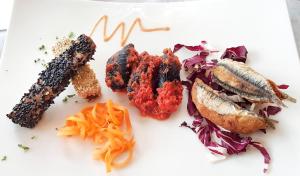 a plate of food with fish and vegetables on it at Hotel Villa Adriana in Monterosso al Mare