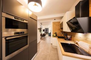 a kitchen with a stainless steel oven and a sink at Apartment Sun n' Sea in Sveti Petar