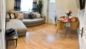 a living room with a couch and a table at Beautiful Apartment in Bristol