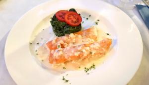 a plate of food with fish and a tomato at Hotel Villa Adriana in Monterosso al Mare