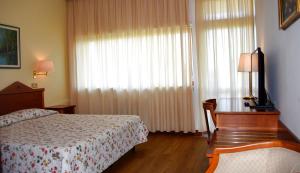 Een bed of bedden in een kamer bij hotel michelangelo