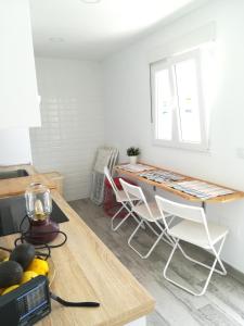 a dining room with a table and chairs at Apartamento La Zarzuela in Zahara de los Atunes +18 photos