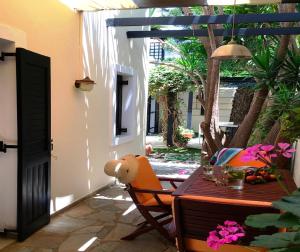 a table with a teddy bear sitting on a patio at Aigialis Apartments & Studios in Kokkini Khanion