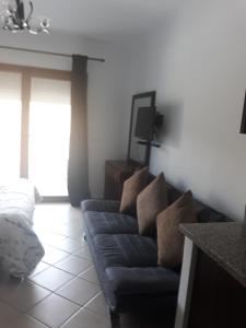 a living room with a couch and a tv at Appart-Hotel Cabo Dream in Cabo Negro