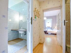 a bathroom with a shower and a sink and a mirror at Muza in Duszniki Zdrój