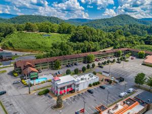 an aerial view of a building with a parking lot at Days Inn By Wyndham Pigeon Forge South in Pigeon Forge