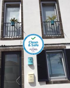 a sign on the side of a building with windows at Casa Physalis in Ponta Delgada