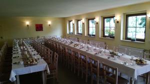 a large room with long tables and chairs at Landpension Wandersruh in Langenberg