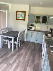 a kitchen with a table and a table and chairs at Gurraun House in Kilkee