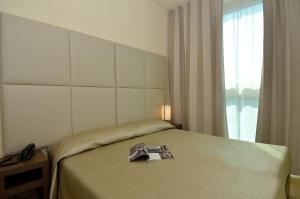 Postel nebo postele na pokoji v ubytování Hotel San Giuliano
