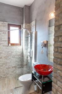 a bathroom with a red sink and a toilet at Aravanes in Thrónos