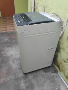 a fax machine sitting on the floor next to a wall at Temerloh Guesthouse for Muslim in Kampong Paya Kerinau