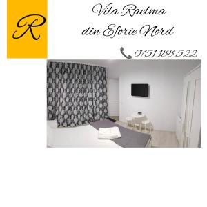 a picture of a room with a table and chairs at Vila Raelma in Eforie Nord