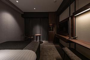 a hotel room with a bed and a television at Hotel Trad Hakata in Fukuoka