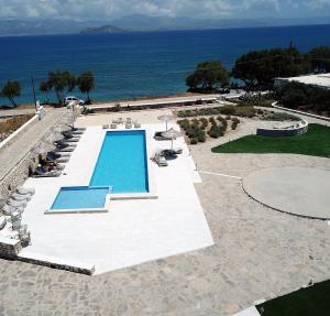 an aerial view of a swimming pool and the ocean at Ambelas Mare Apartments in Ambelas