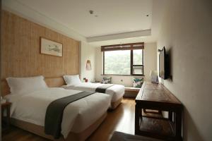 Una cama o camas en una habitación de 武当山太和紫隐酒店