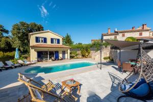 a villa with a swimming pool and a house at Villa Rose in Kršan