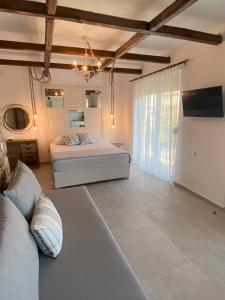 a living room with two beds and a couch at Oliva in Faliraki