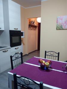 a kitchen with a table with a bowl of fruit on it at Appartamento Flora in Tremosine Sul Garda