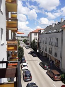 a view of a city street with cars parked at Macskafogo, tunderi szallas a belvarosban in Győr