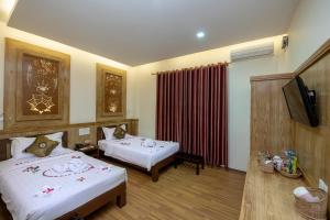 A bed or beds in a room at UCT Taunggyi Hotel