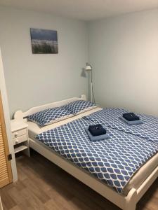 a bedroom with a bed with two towels on it at Dārza māja in Liepāja