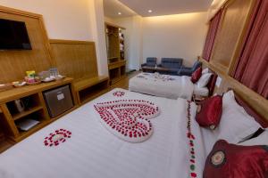 A bed or beds in a room at UCT Taunggyi Hotel