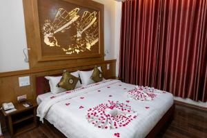 A bed or beds in a room at UCT Taunggyi Hotel