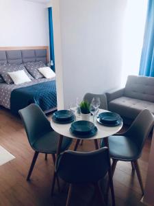 a room with a table and chairs and a bed at apartamentc312 Bel Mare in Międzyzdroje
