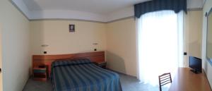 Postel nebo postele na pokoji v ubytování Hotel Pegaso