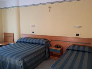 Postel nebo postele na pokoji v ubytování Hotel Pegaso