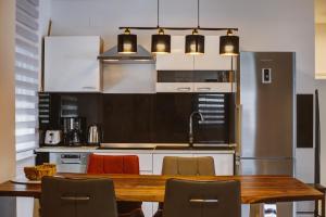 a kitchen with a wooden table and some chairs at Apartman Izzy in Senj