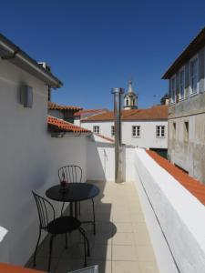 um ptio com duas cadeiras e uma mesa num edifcio em Casa Porta de Santiago em Pinhel
