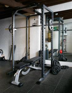 a gym with two squat racks and weights at Amberoo Apartments Tamworth in Tamworth