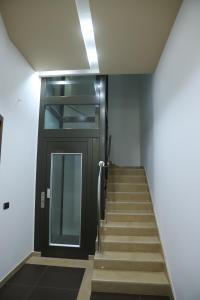 a stairway with a black door and a stair case at La Luna e il Sole in Barletta