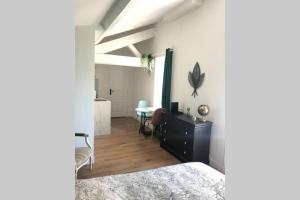 a bedroom with a table and a dining room at Studio sous les toits in Lyon +1 photo