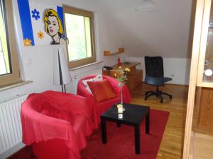 a living room with two chairs and a table at Ferienwohnung Carmen in Siegen