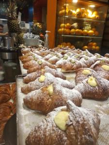 a bunch of pastries on display in a bakery at Hotel Genziana in Genova