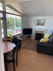 a living room with a couch and a table at Chalet18 in Carmarthen