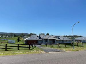 a farm with a fence and some houses at Rosehill Vines in Millfield