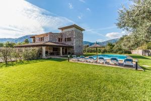 an estate with a swimming pool and a house at Villa La Rafal By homevillas360 in Pollença
