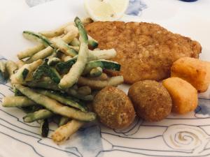 a plate of food with fried meat and french fries at Hotel Bahia in San Benedetto del Tronto +75 photos