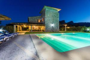 eine Villa mit Swimmingpool bei Nacht in der Unterkunft Villa La Rafal By homevillas360 in Pollença