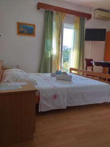 a bedroom with a white bed with a window at Apartment Stella in Murter +84 photos