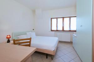 Llit o llits en una habitació de Casa GINESTRA a Bagno Vignoni