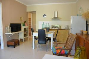 a kitchen with a table and chairs and a refrigerator at Villa Physis in Parga