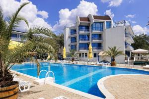 a hotel with a swimming pool in front of a building at Hotel Iceberg in Balchik
