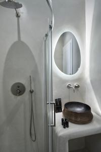 a bathroom with a sink and a mirror at Galation in Mýkonos City