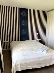 a bed in a bedroom with black and white stripes at 2 rum och kök på Färjestad in Karlstad