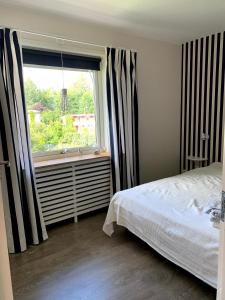 a bedroom with a bed and a large window at 2 rum och kök på Färjestad in Karlstad